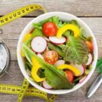 Intermittent fasting concepts showing a clock and healthy foods that boost metabolism and brain function